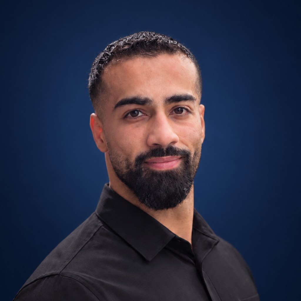 Portrait of Aladdin Hamed against a navy background.
